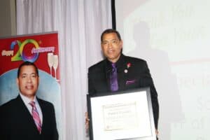 man wearing a suit receiving an award
