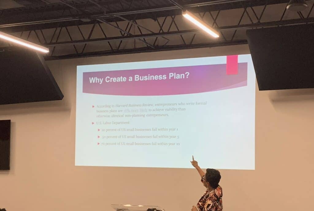 powerpoint presentation on a screen with someone pointing at the screen