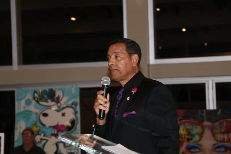 man in a suit holding a microphone