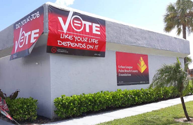 building with red vote sign on it
