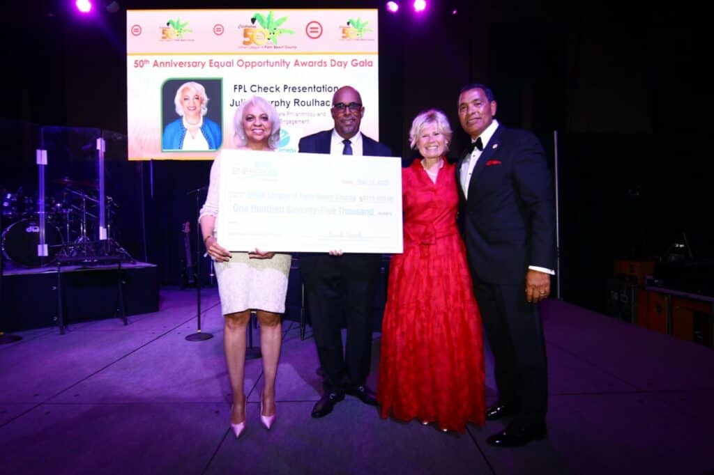 group of people holding check