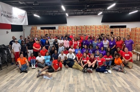 group of volunteers posing in front of boxes